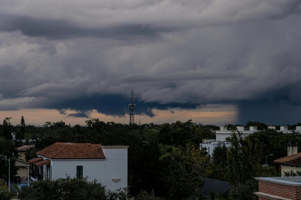 Seasonal weather changing over a city skyline with dark storm clouds and shifting conditions