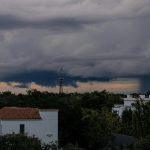 Seasonal weather changing over a city skyline with dark storm clouds and shifting conditions