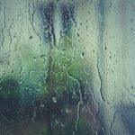 Sudden heavy rain causing fast runoff and daily weather disruption on a road surface