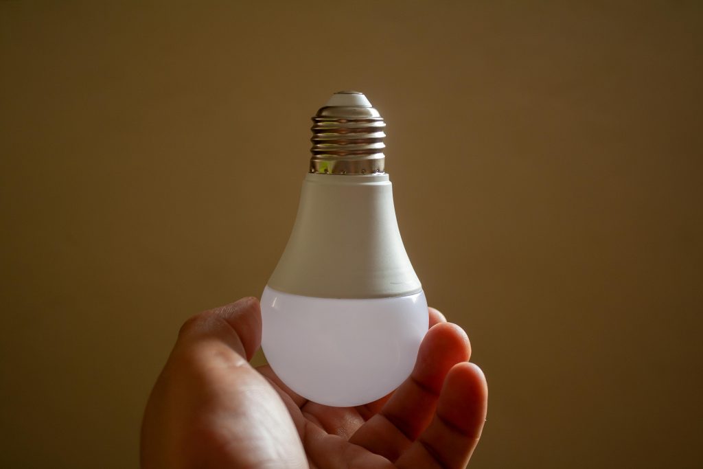 Home energy efficiency represented by an LED light bulb in a household setting