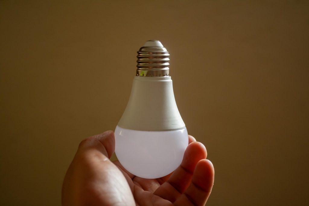 Home energy efficiency represented by an LED light bulb in a household setting