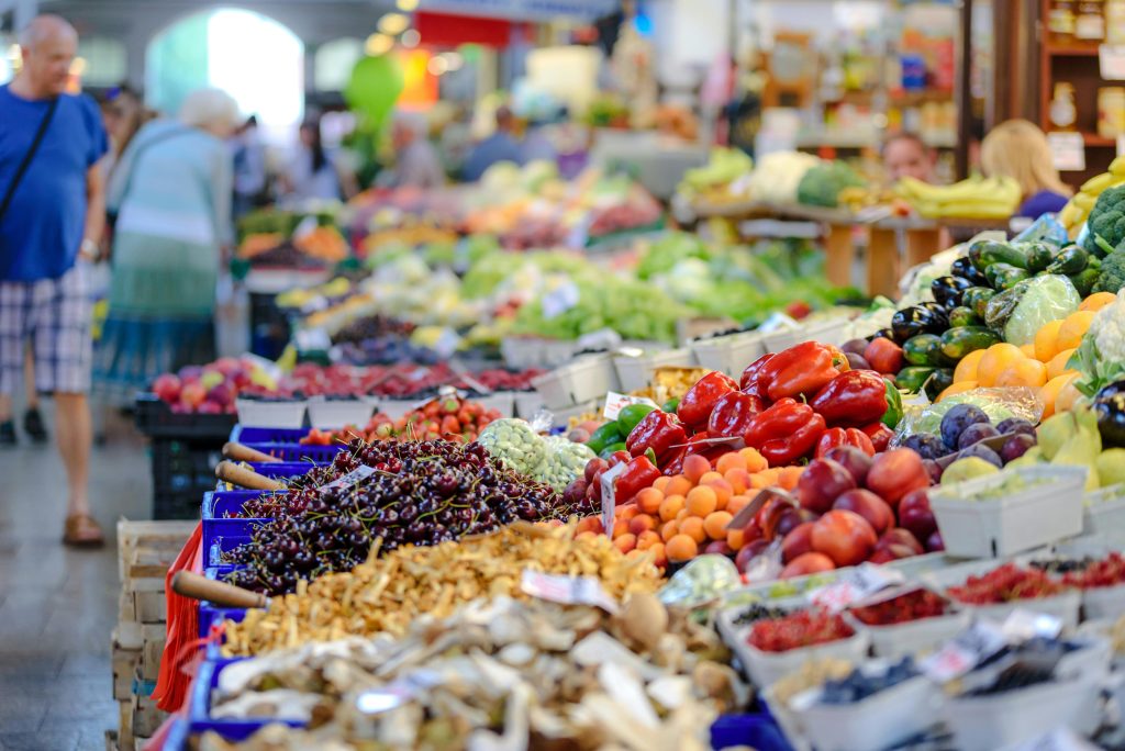 Local food systems shown through a farmers market with fresh produce
