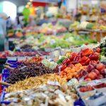 Local food systems shown through a farmers market with fresh produce