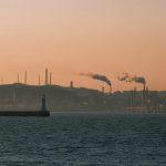 Poor air quality over an industrial urban shoreline at sunset