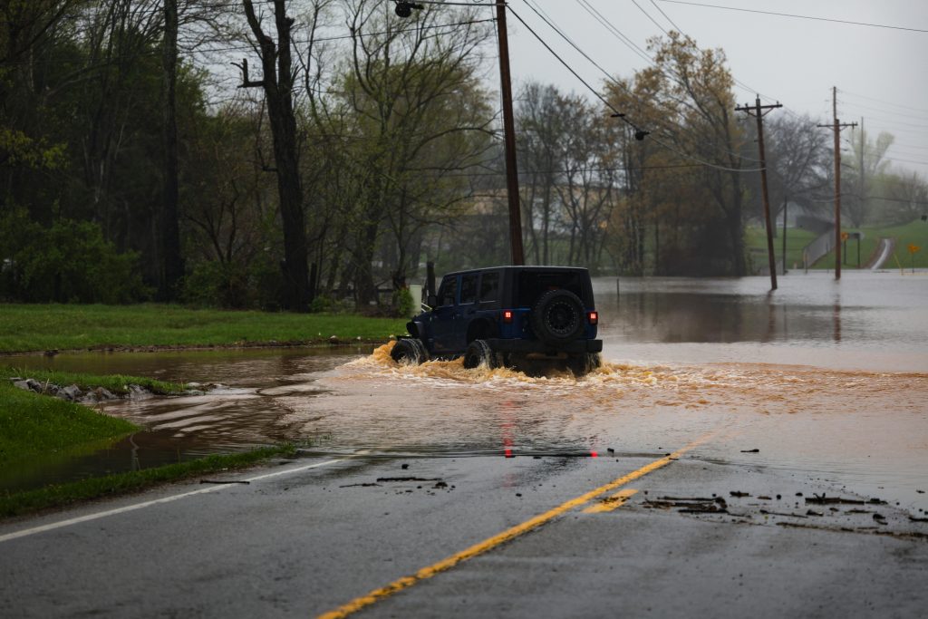 Everyday climate impacts shown by heavy rainfall and local flooding on a suburban street