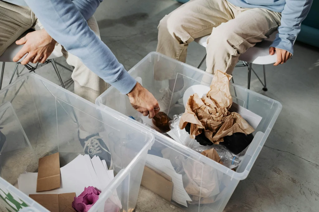 Clear labels on home bins helping a household member improve sorting during cleanup
