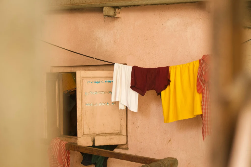Drying clothes earlier in the day to help a home feel cooler indoors during warm weather