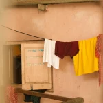 Drying clothes earlier in the day to help a home feel cooler indoors during warm weather
