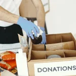 Small donation box at home holding useful items to help lower household waste