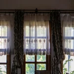 Using curtains earlier to help rooms stay cooler before direct sun heats the home