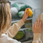 Running eat-first note on a refrigerator helping reduce forgotten food at home