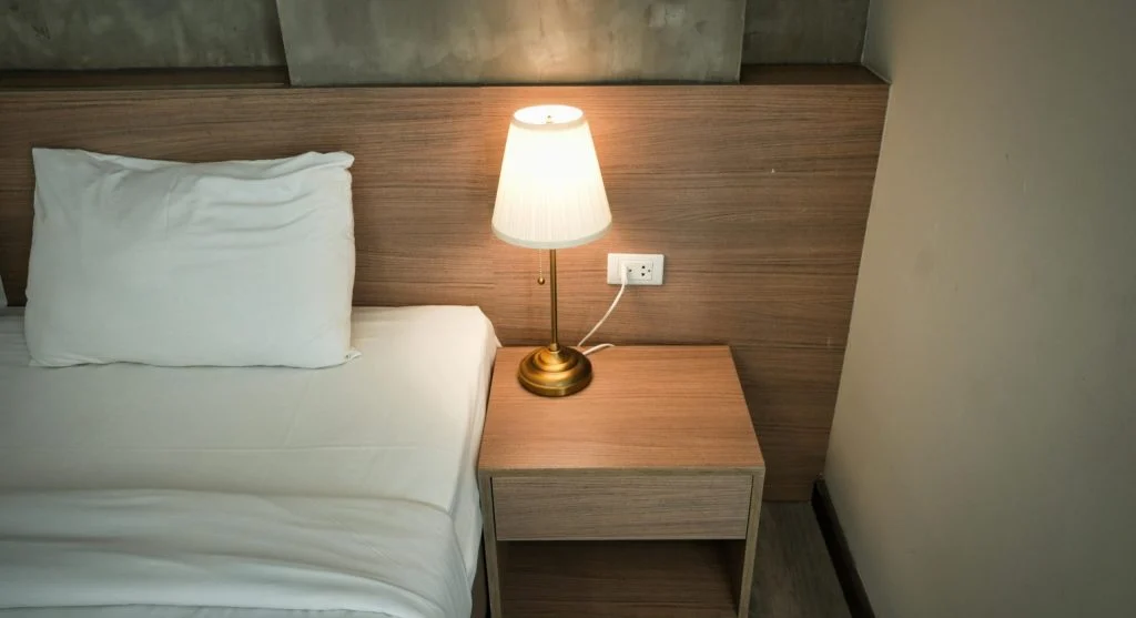 Using task lighting at night with a bedside lamp to reduce full-room lighting use