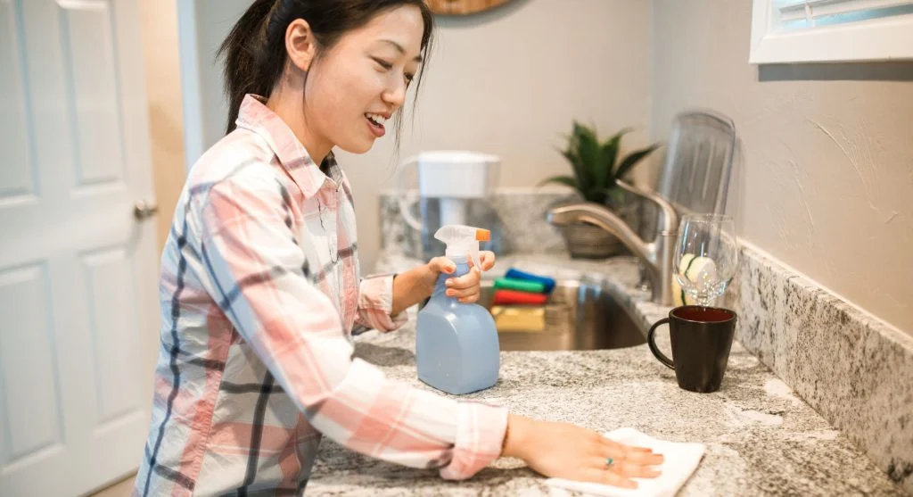 Reusable cleaning cloths within reach on a counter to help cut household waste during daily cleaning
