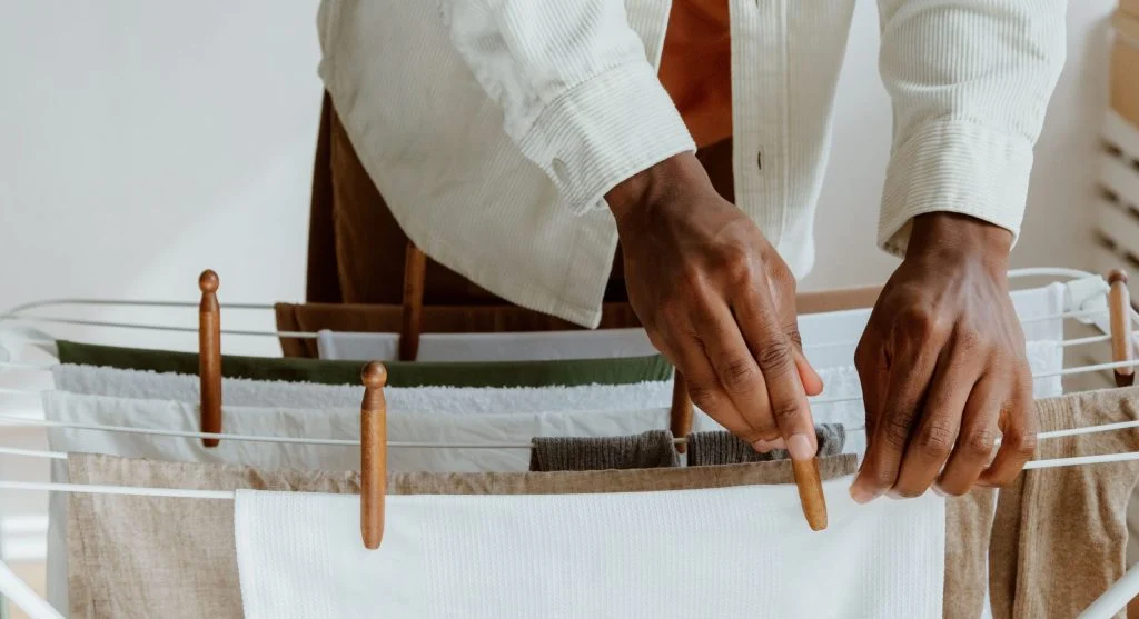 Drying thicker laundry items in smaller batches indoors to avoid heavy damp air