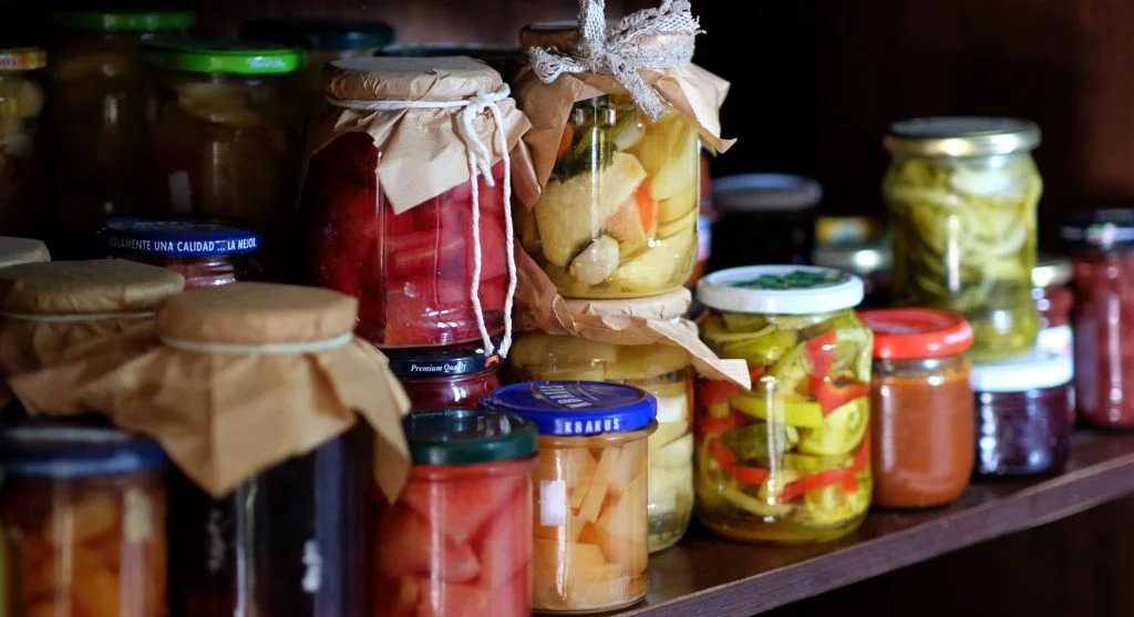 Pantry cans and jars arranged in date order to support better shelf-stable food use